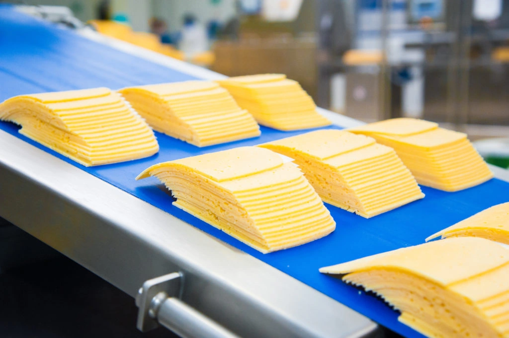 Cheese slices on a conveyor belt